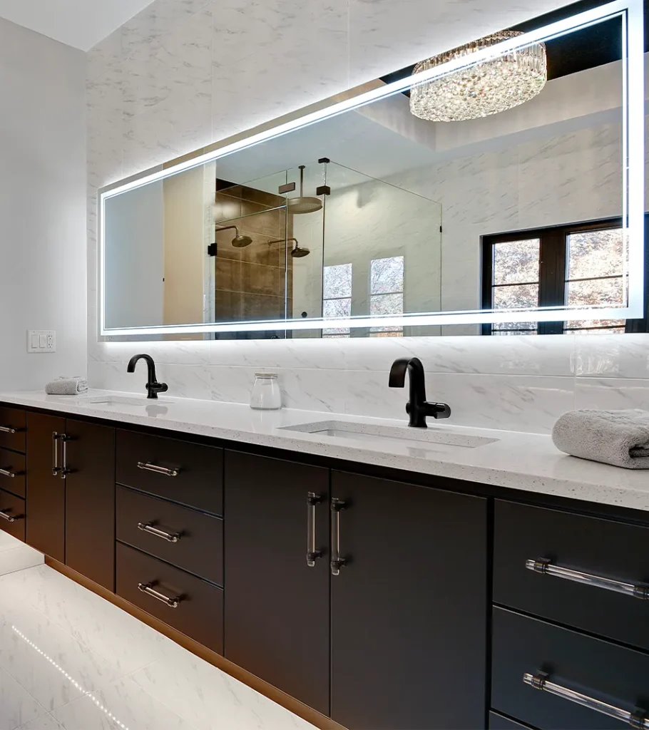 Double vanity bathroom with dark wood cabinets, white countertops, and modern lighting