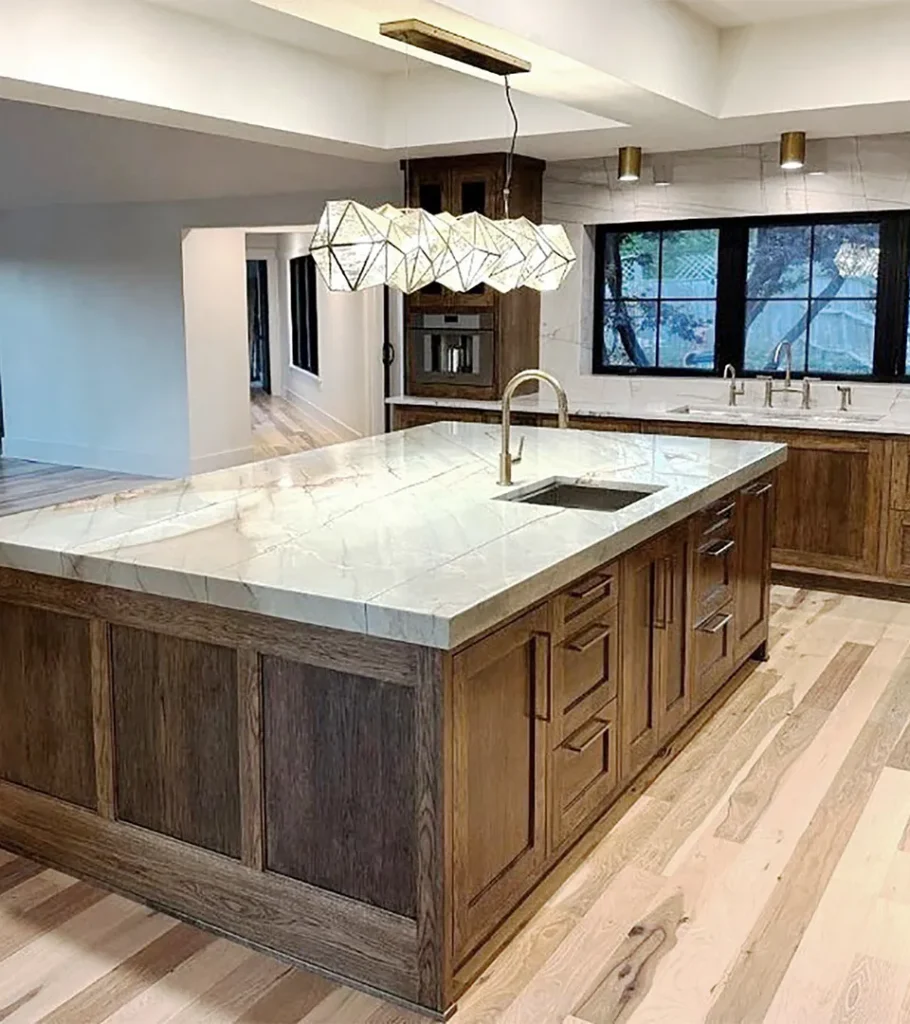 Contemporary kitchen island with waterfall marble countertop and wood cabinetry