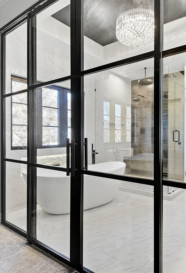 Luxury bathroom renovation featuring double vanity, tile shower, and modern fixtures