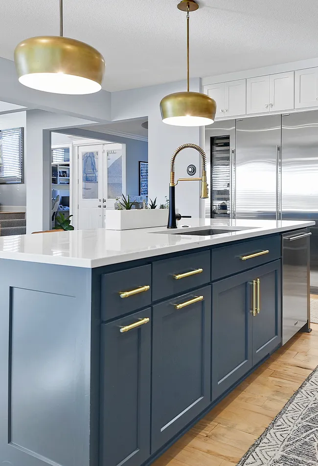Modern kitchen remodel in Overland Park KS featuring white cabinetry, quartz countertops, and a large center island