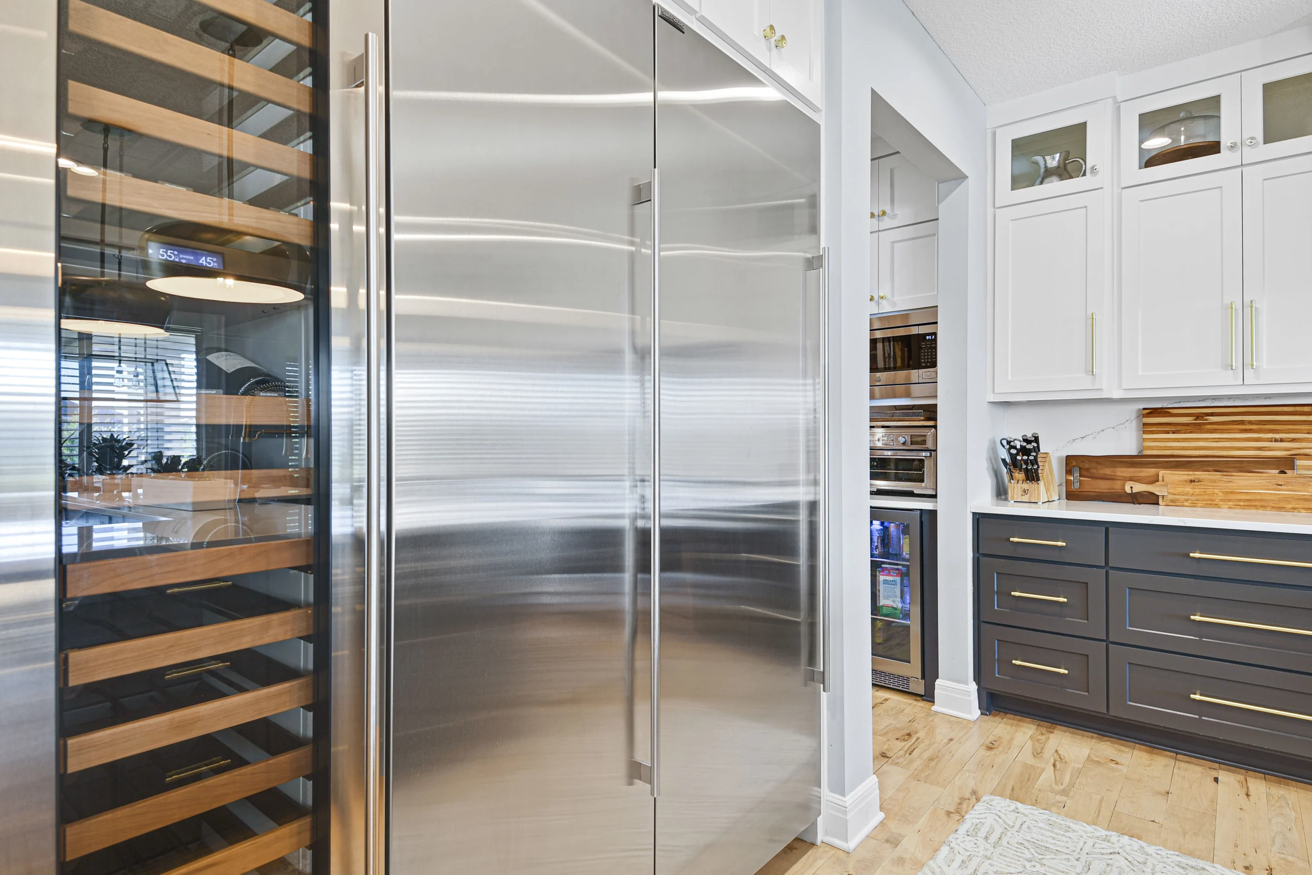 Modern kitchen remodel in Overland Park Kansas with built-in wine refrigerator and custom cabinetry