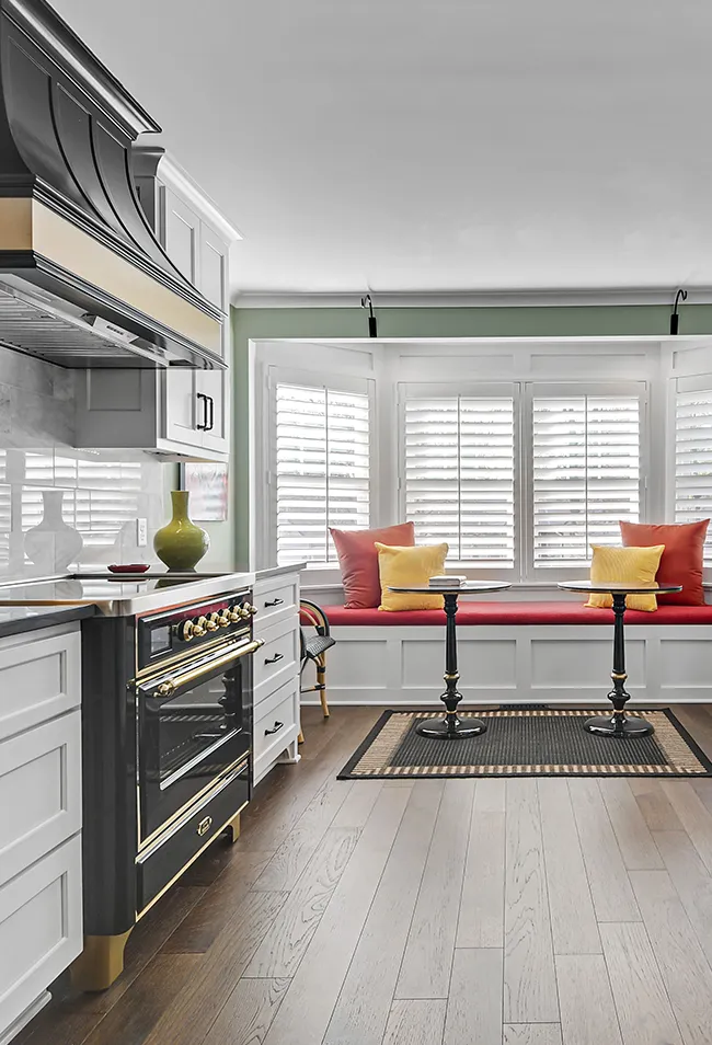 Custom kitchen renovation in Prairie Village KS with white cabinetry, stone countertops, and modern lighting